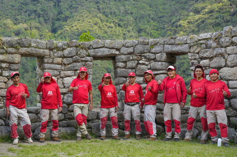 our inca trail porters posing for picture in wiñaywayna ruins 